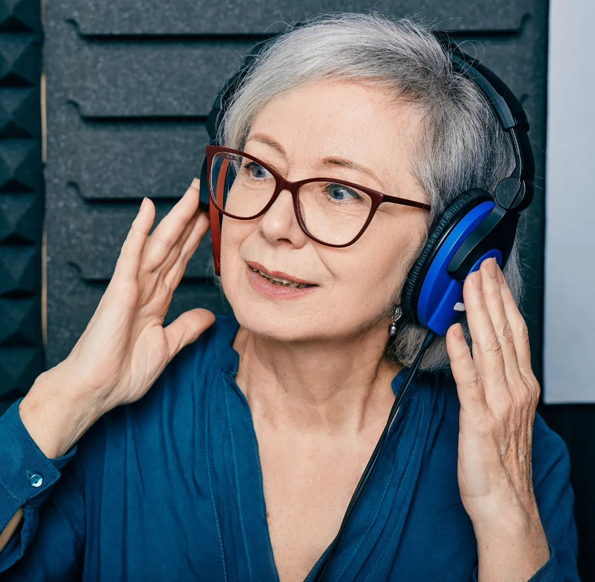 Alpha Hearing woman client with headphones for hearing test