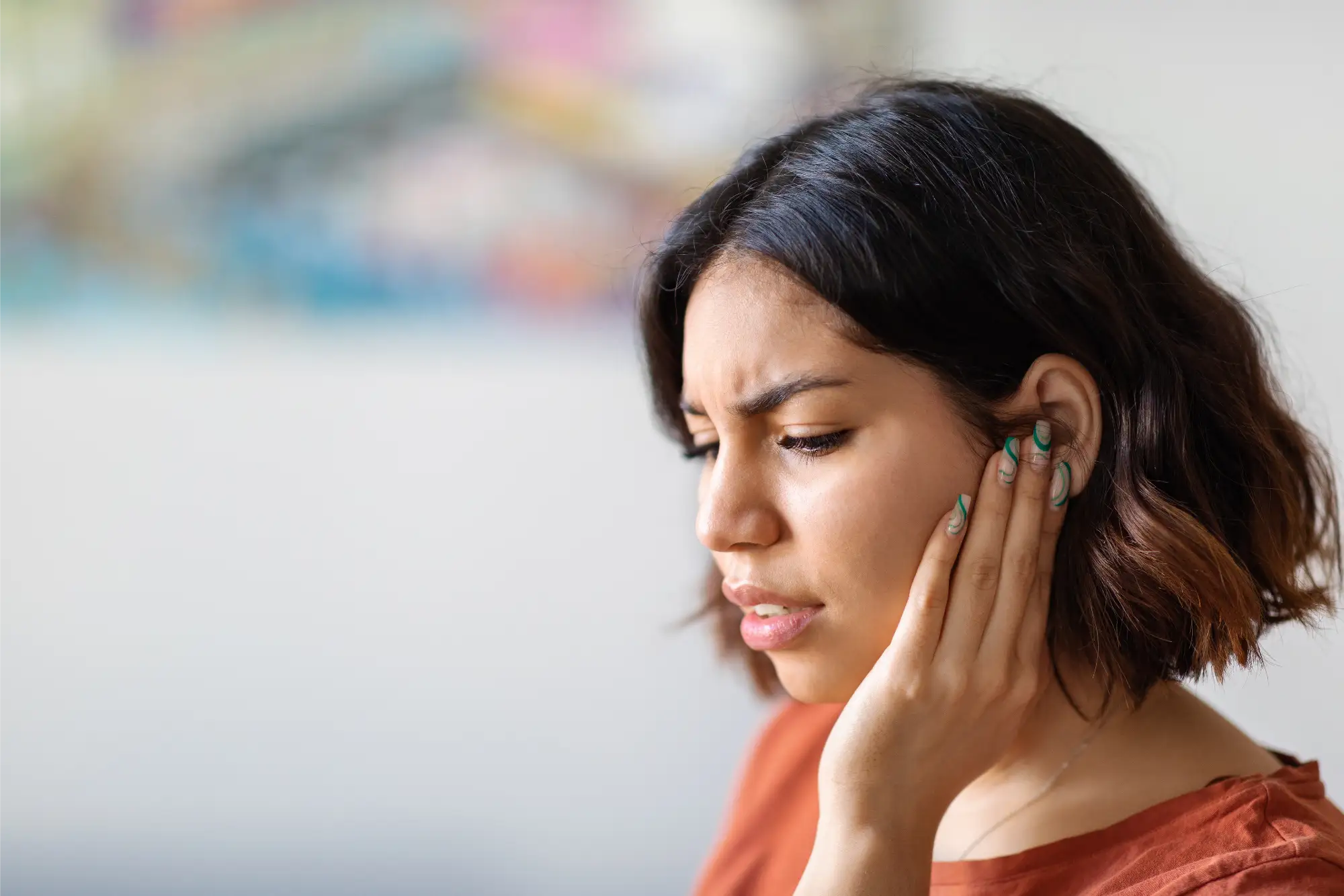 man wearing hearing aids leaning against verandar