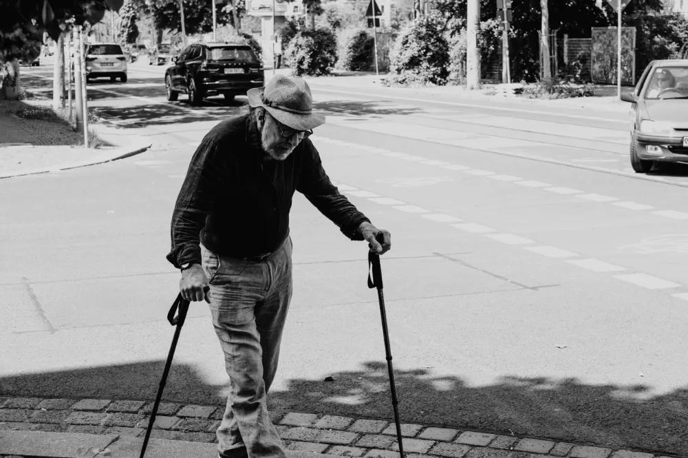 old man with walking sticks photo credit miikka-luotio-lU1pxZmWoto-unsplash