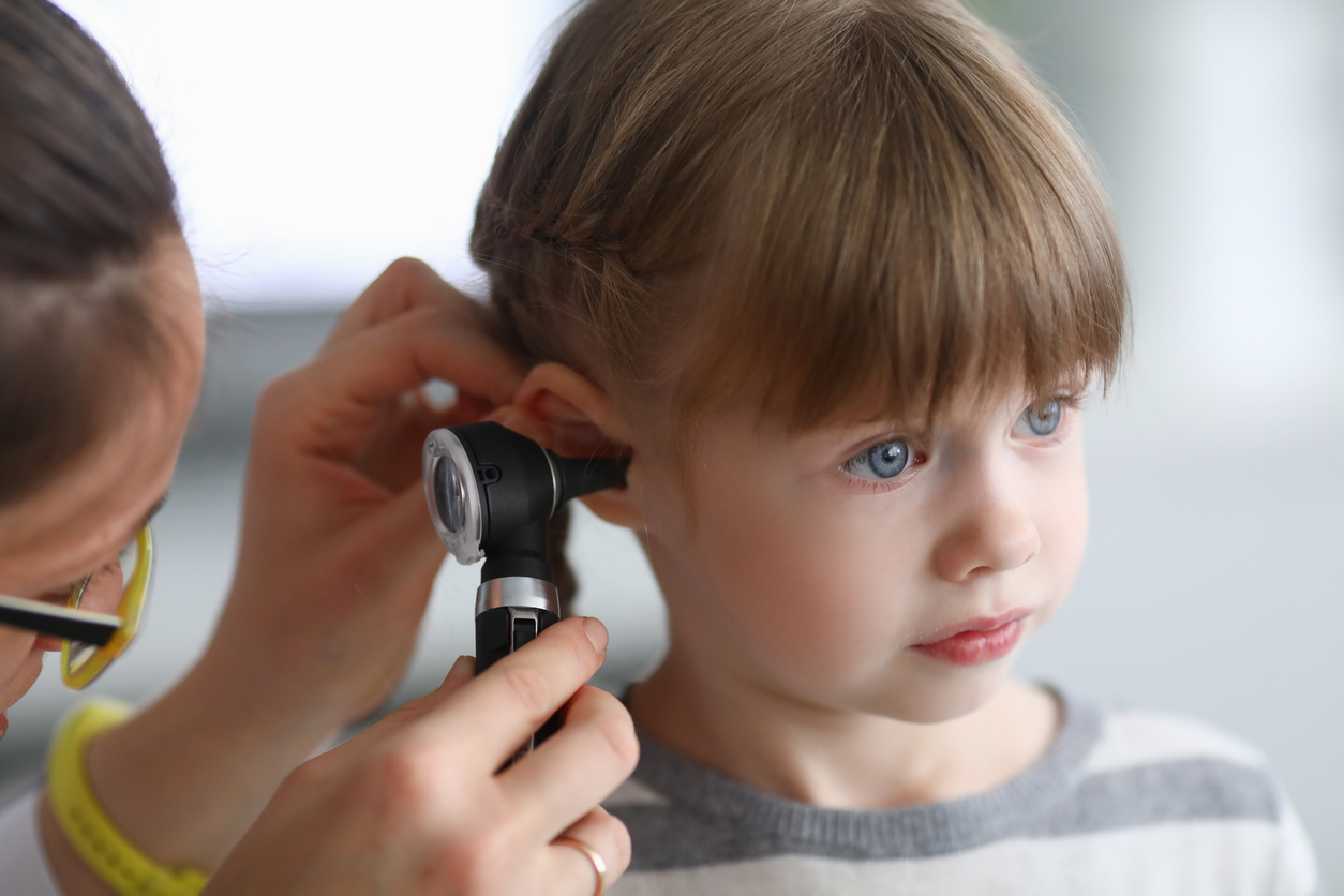 Alpha Hearing woman client with headphones for hearing test