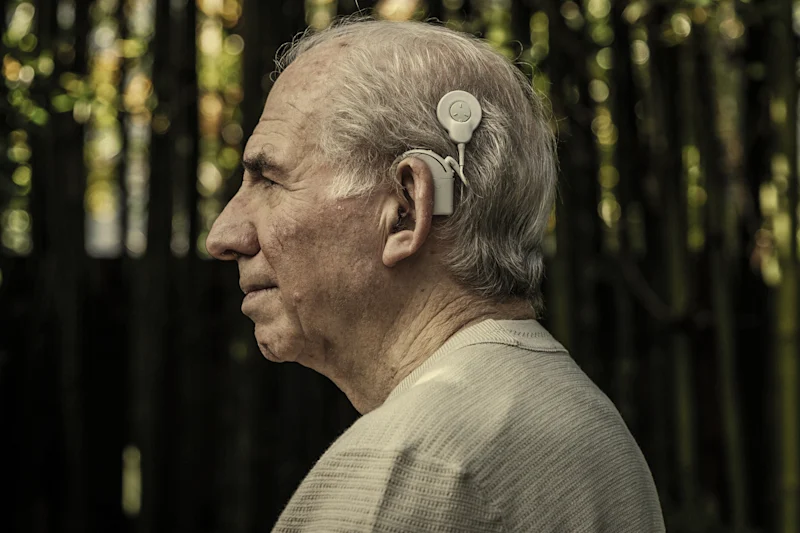 Article 9 Michael Bruce has had a cochlear implant for each ear: “The words are so much clearer now.”Credit: Paul Jeffers, digitally tinted<br />
